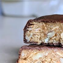 A thick cookie dipped in chocolate and cut to show the inside