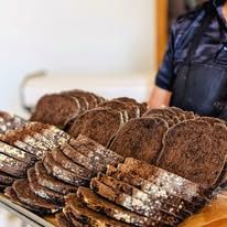 Sliced dark loaves on a baking tray