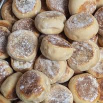 Floury English muffins piled together