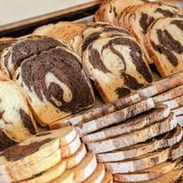 Sliced marbled rye loaves with a dark and light swirl