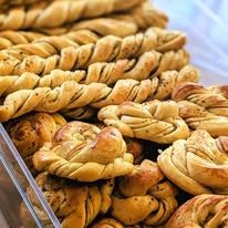 Golden twisted pastries on baking trays