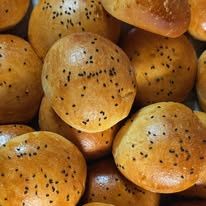 Golden brioche buns sprinkled with seeds