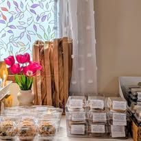Fresh flowers and packaged bakes on our shop counter